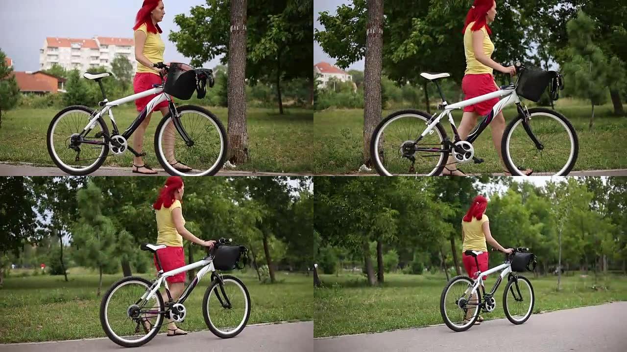 骑自行车走路的红发女人
