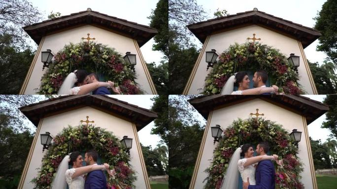 快乐的新婚夫妇在教堂接吻