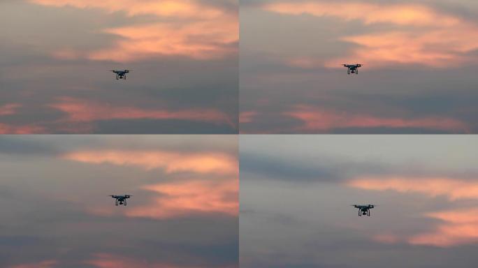 无人机四轴直升机，数码相机在日落时盘旋