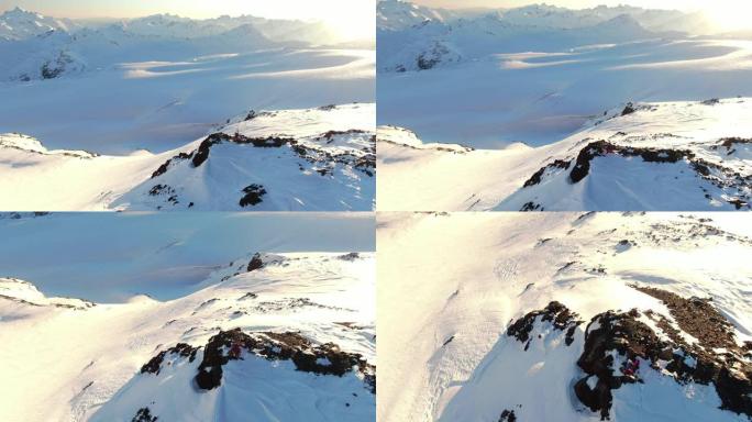 在雪山边缘拍摄滑雪者的空中垂直无人机