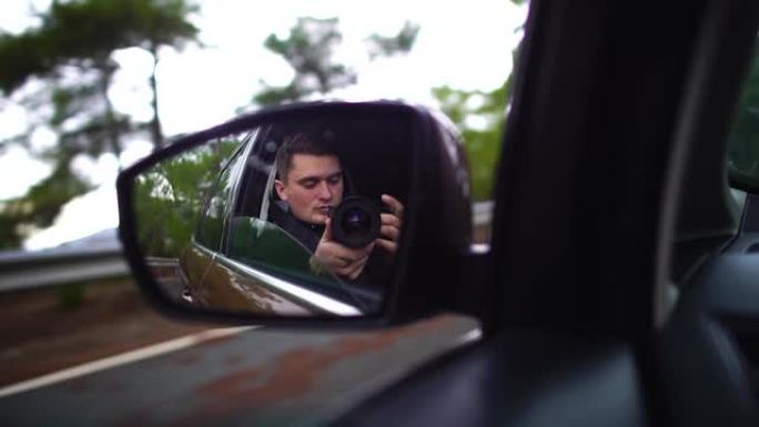 在行驶中的汽车后视镜中带有摄像头的人