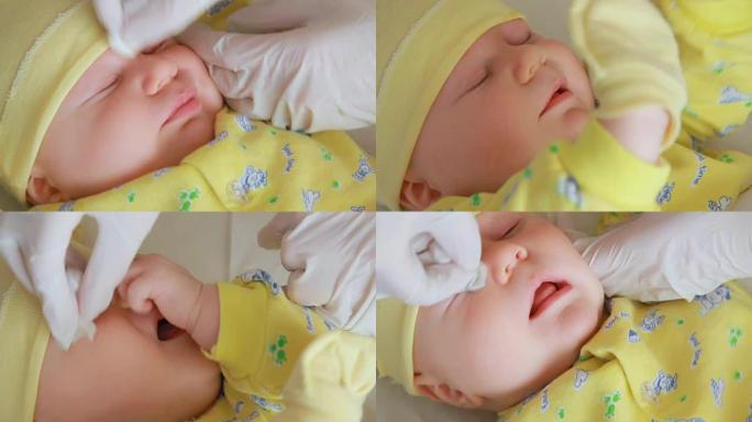 母亲正在清洁婴儿的眼睛