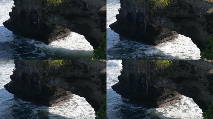 高清:海浪冲击悬崖印度教寺庙在海滩巴厘岛，塔纳Lot寺庙在巴厘岛，印度尼西亚