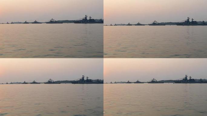 日落时海湾中的军用船只