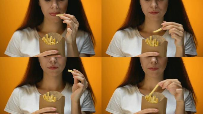 女孩吃薯条，享受快餐，高热量膳食，肥胖风险