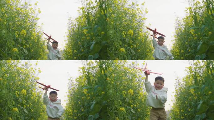 小男孩拿着飞机模型田间奔跑欢乐童年儿童节