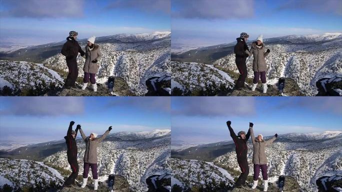 年轻夫妇在山顶上玩得开心，令人惊叹的冬季环境