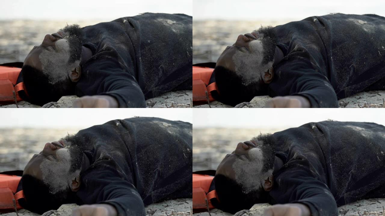 带有弓步创伤的黑人男子深呼吸躺在海滩上，自然灾害