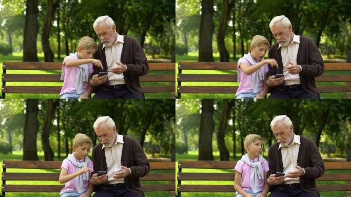 男孩教爷爷使用智能手机，养老金领取者难以获得新技术