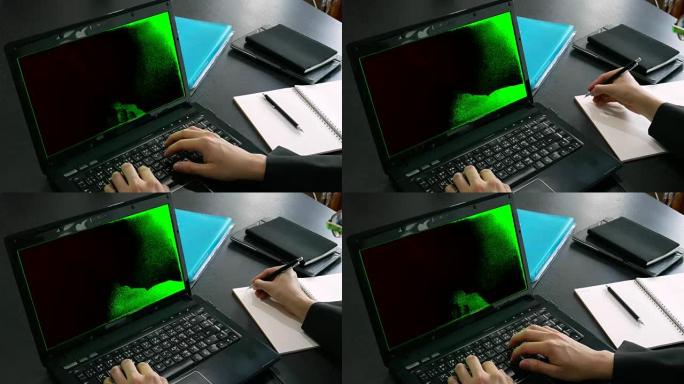 商务人士手在办公室使用带色度键的绿色屏幕笔记本电脑和笔记本上书写