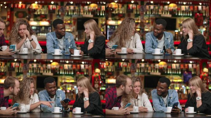 在朋友公司讲有趣的故事。跨国男人和女人坐在一起喝咖啡的桌子旁