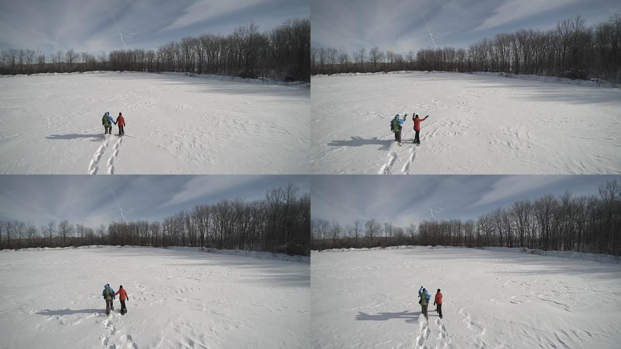 鸟瞰图家庭冬季户外雪鞋行走