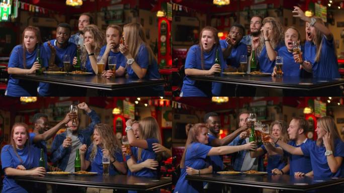 一群多民族的穿着蓝色t恤的球迷朋友将在酒吧观看电视上的比赛，观看紧张的激动人心的时刻并庆祝进球。拥抱
