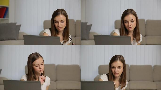 紧张的女商人坐在办公桌前用笔记本电脑工作