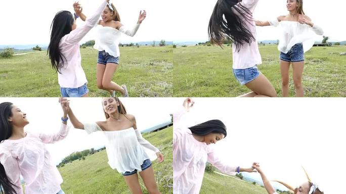 两个年轻的嬉皮士女人在草原上跳舞，慢动作