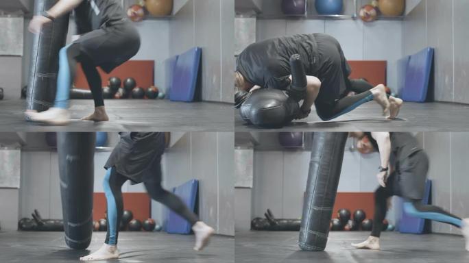 运动高加索男子在体育俱乐部打架模特。自信强壮的运动员在健身房用设备训练拳击场上的肖像。混合武术，运动