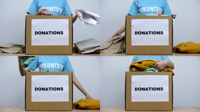 善良的女性活动家将衣服放在桌子上的捐款箱中，孤儿院护理