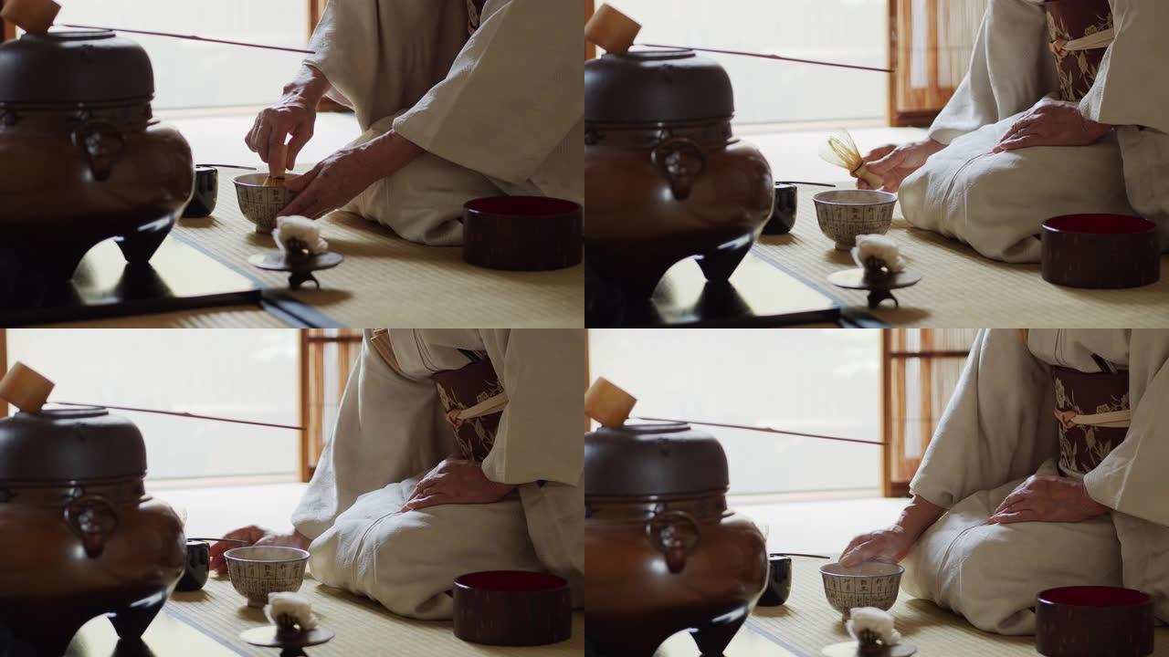 在传统的日本茶道上主持搅拌茶并提供碗