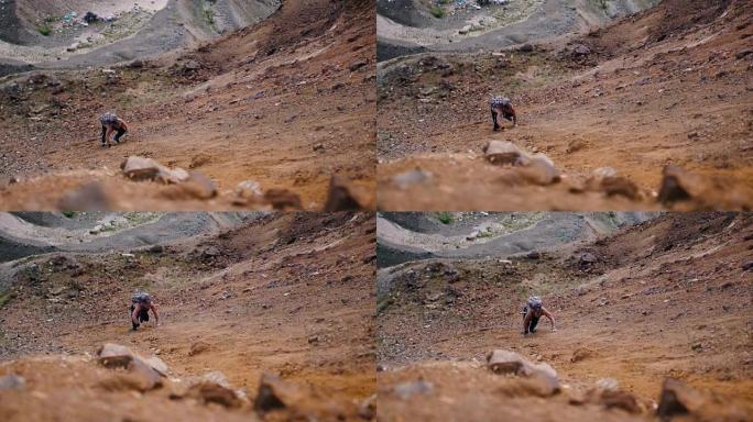 徒步旅行者悬崖山艰难爬行挑战自我山坡爬山