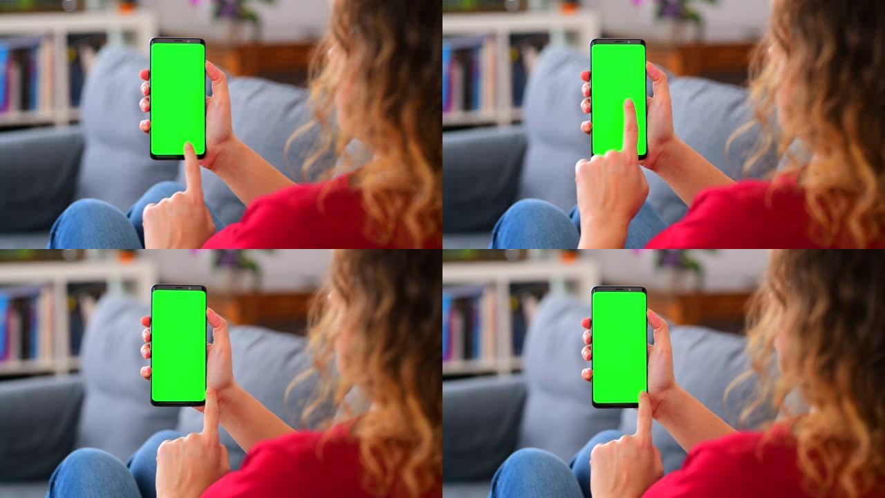 女人在家里使用色度键屏幕智能手机滑动和点击