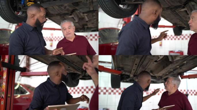 机械师在维修店向客户解释他的汽车缺陷