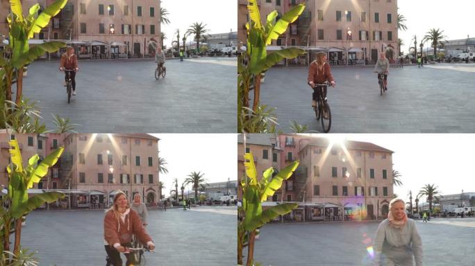 妇女骑自行车穿过乡村广场
