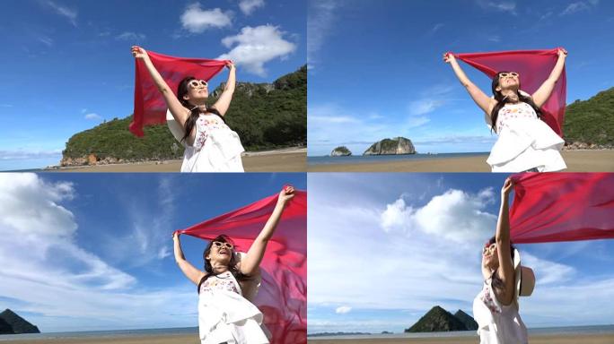 丝绸面料的幸福女人站在美丽的海滩上，在阳光明媚的海景中自由自在