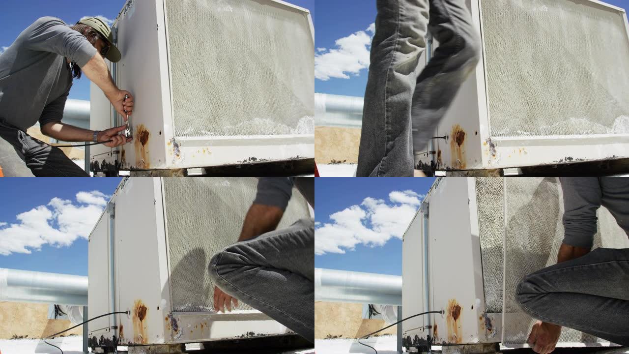 四十多岁的高加索杂工使用可调扳手拧紧屋顶沼泽冷却器外部的连接，然后卸下其中一个屏幕并检查冷却垫，同时