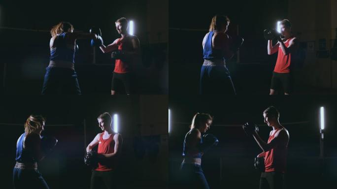 年轻的成年女子与教练一起进行跆拳道训练