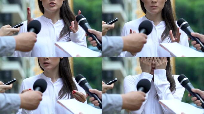 愤怒的女人遮住脸的手，厌倦了烦人的记者采访