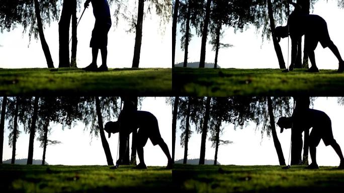 高尔夫球手在高尔夫球场上开球，剪影