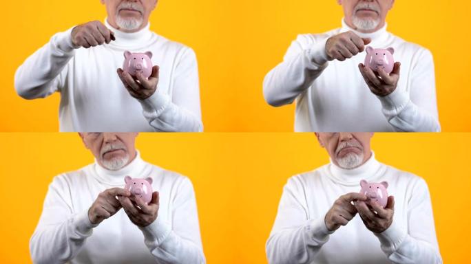 高级绅士将硬币放在橙色背景的存钱罐中，养老基金