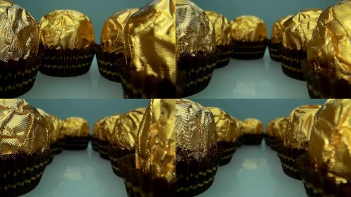 相机在成排的美味美丽的巧克力球糖果旁边缓慢移动