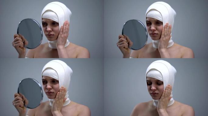 女性穿着弹性头套照镜子，整容后感到疼痛
