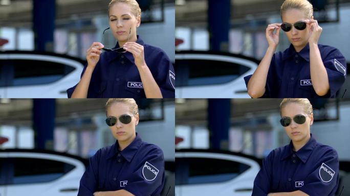 穿着制服的警察妇女戴着墨镜，着装规范，职业道德