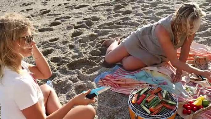 母女俩在海滩上烧烤做饭