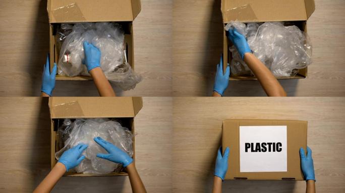 戴手套的下车站志愿者接受盒子里的塑料垃圾，重复使用