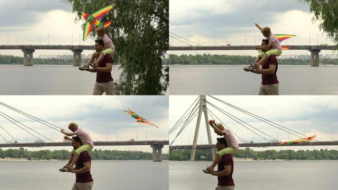 父子在河边放风筝，一起快乐时光，父母爱