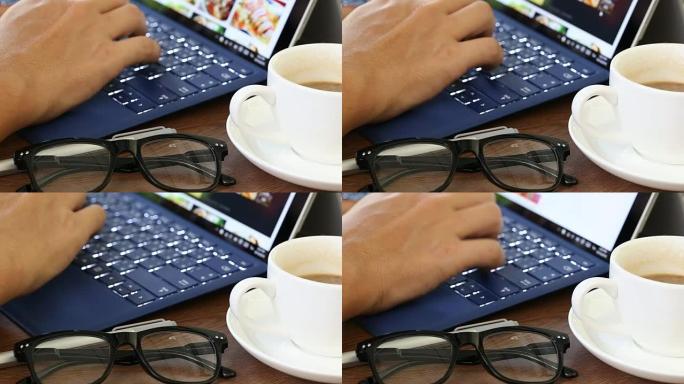 在办公室里，一个人在笔记本电脑键盘上打字。