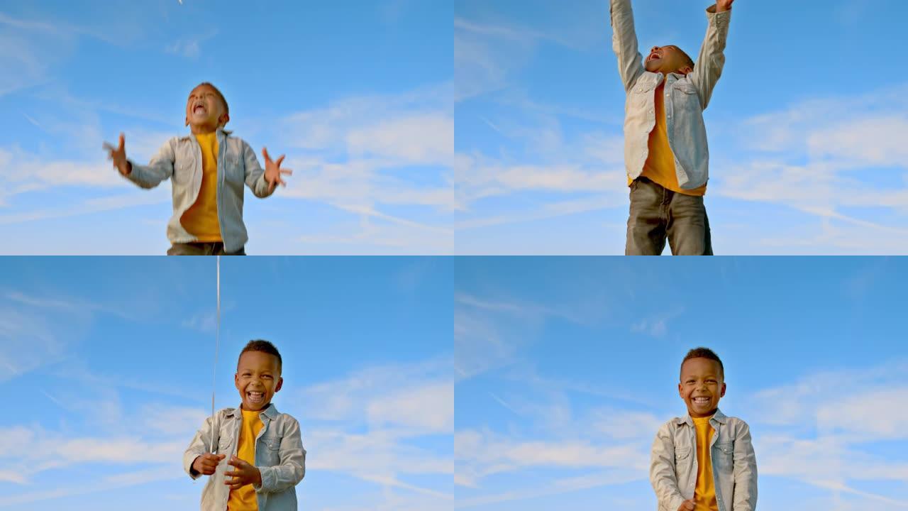 SLO MO小男孩让气球漂浮到天空后跳跃并微笑