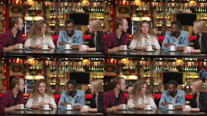 一家跨国公司的朋友在餐厅喝咖啡和聊天。四个朋友聊天。