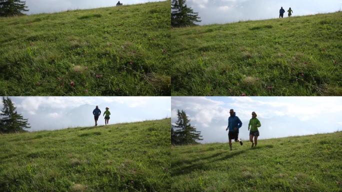 越野跑者在日出时登上高山草甸