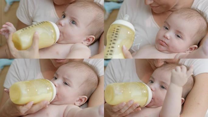 妈妈一边给婴儿喂奶一边擦婴儿的嘴