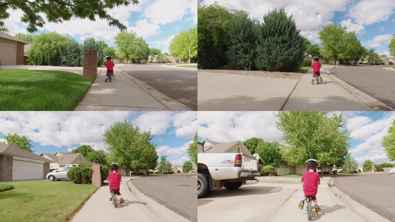 一个四岁的白人男孩戴着自行车头盔，在多云的天空下骑着他的平衡车穿过居民区