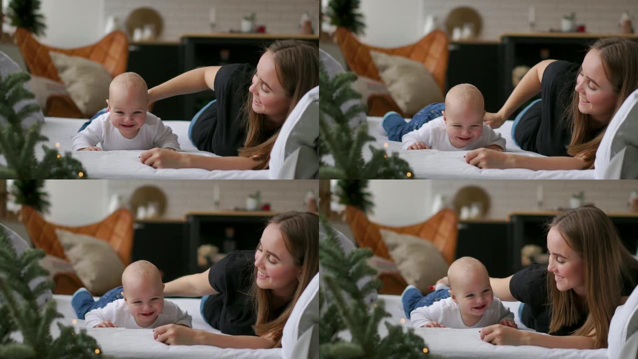 一生中最美好的时刻，一位充满爱心的快乐年轻母亲在白雪公主的毯子上，在白色的背景上拥抱着一个哺乳的儿子
