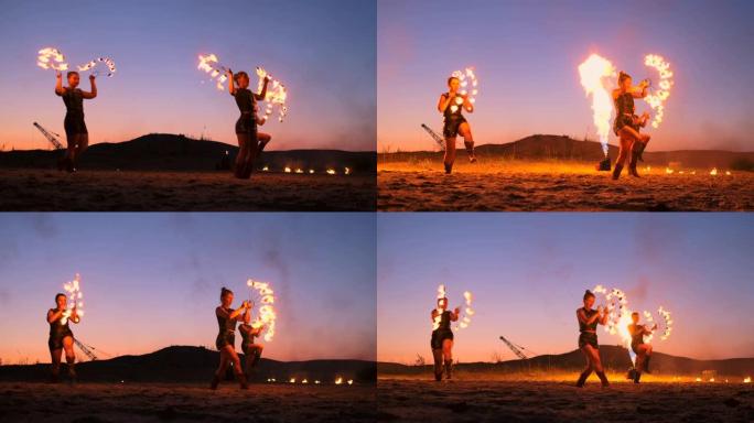 专业艺术家在夏季的沙滩上慢动作表演了一场火表演。马戏团的第四人杂技演员晚上在海滩上用火。