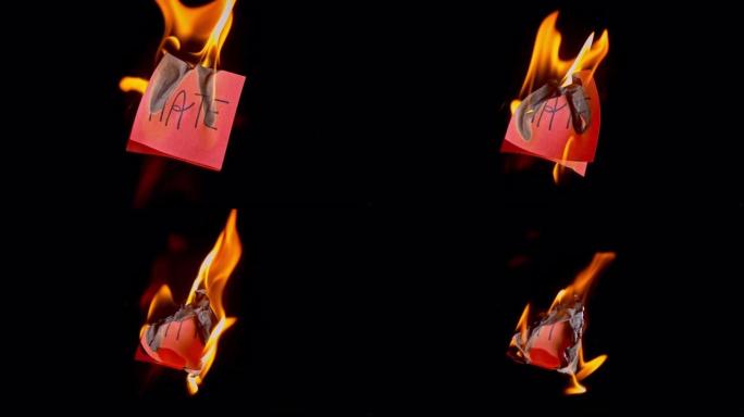 SLO MO LD红色纸上刻有 “仇恨” 字样着火
