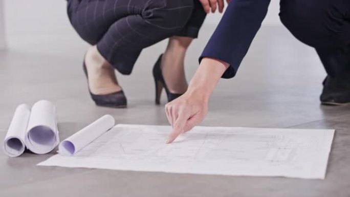 DS女性投资者和女性室内建筑师指出了在空荡荡的建筑物地板上制定的计划的细节，并进行了讨论