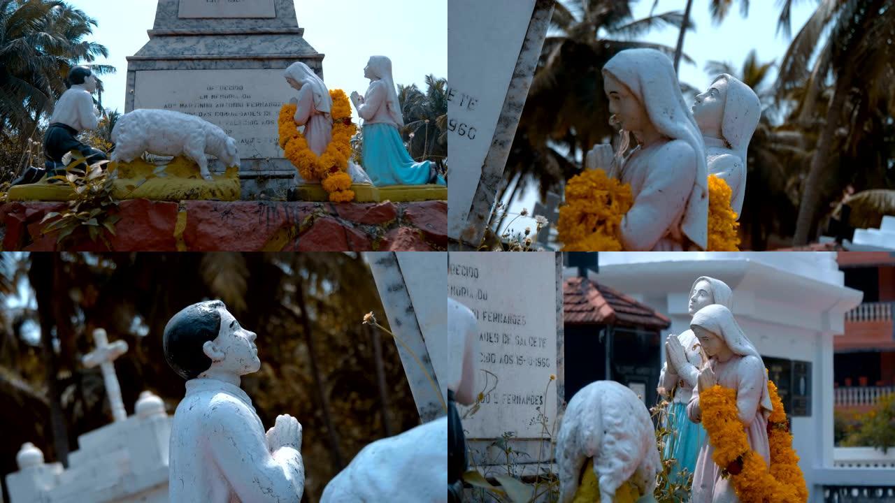 向印度果阿圣母玛利亚祈祷的女孩和男孩的白色雕像