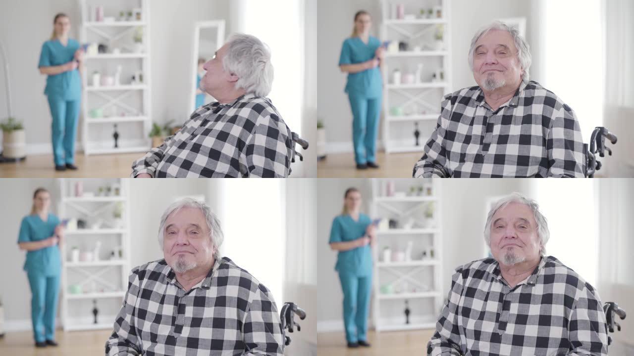 快乐的白种人的肖像白发退休人员回头看着护士，转向相机，摇摇头示意yes。住在疗养院的老人。帮助、援助